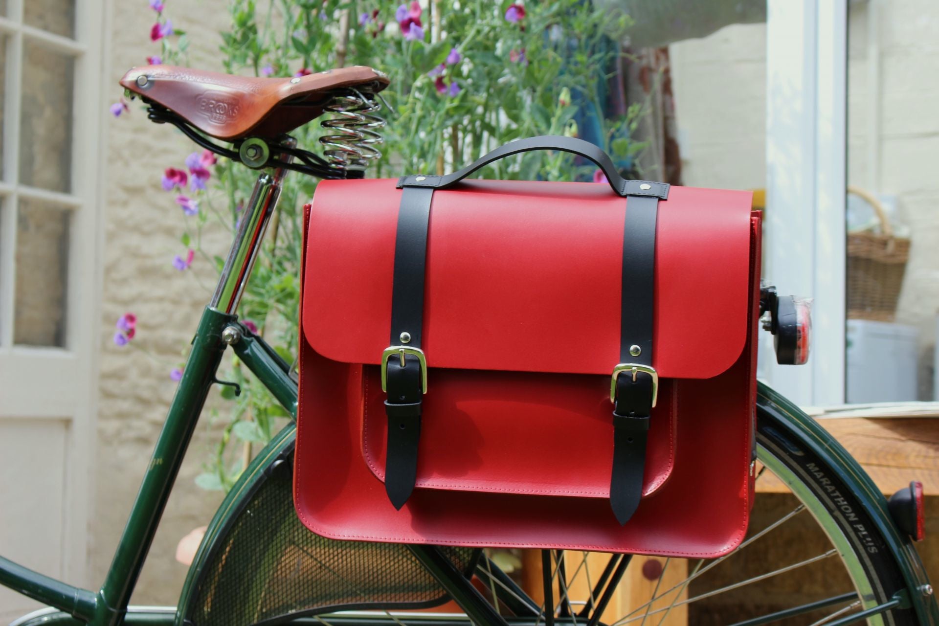 Hill anEllis Birtie Red Leather Pannier on a black bicycle