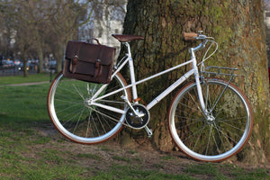 Hill and Ellis Fredie Classic Dark Brown Satchel on a white bicycle