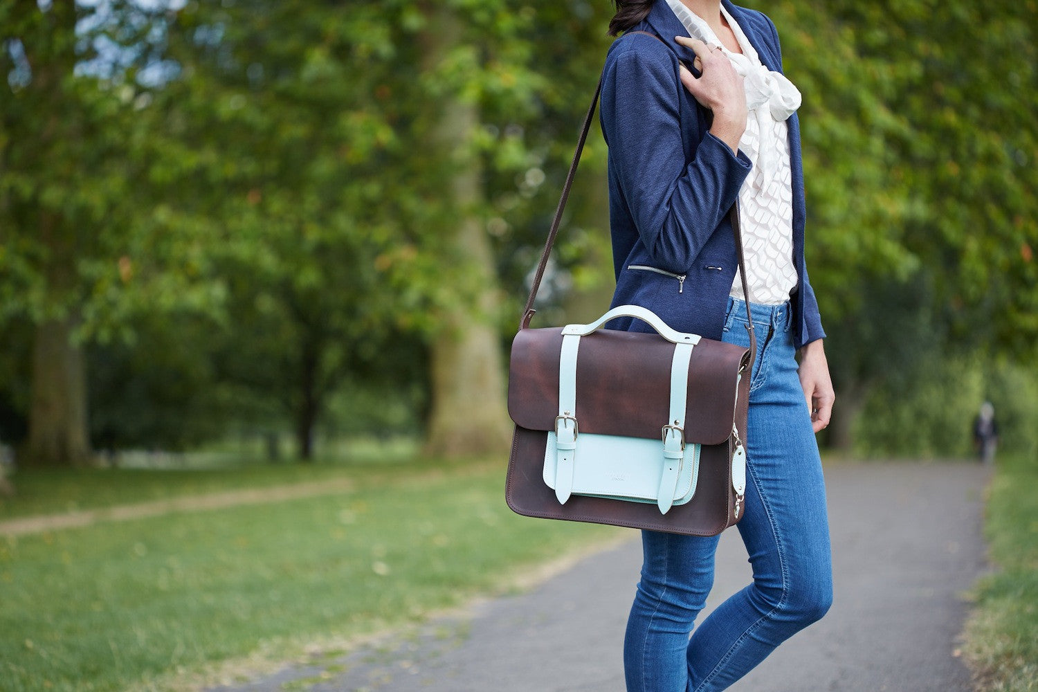 Don Dark Brown and Cambridge Blue Leather Pannier with female model carrying the pannier over her shoulder