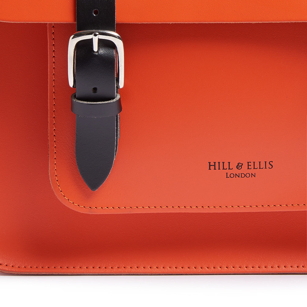 Hill and Ellis Jasper Dutch Orange Leather Pannier front view showing buckle and logo